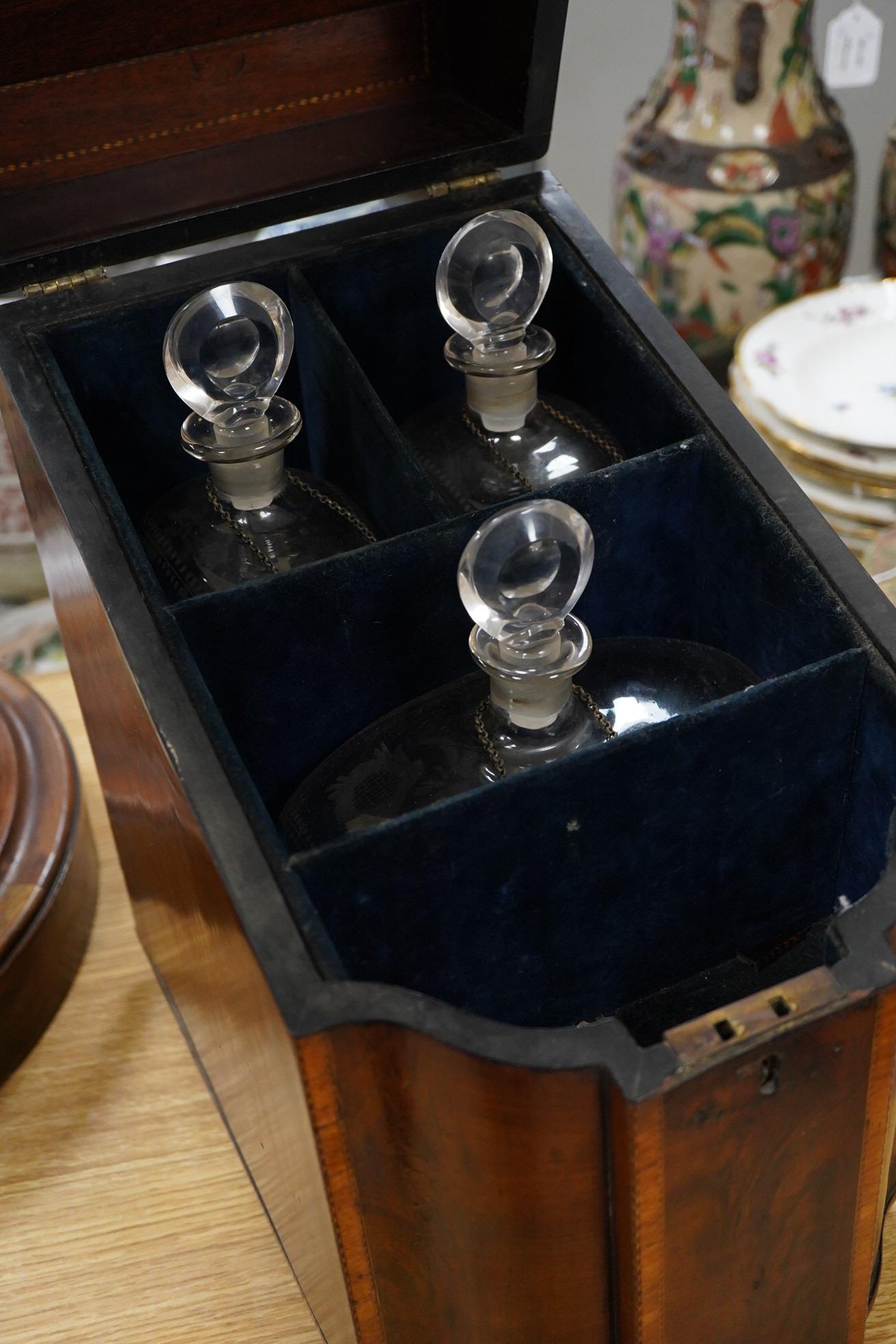 A George III inlaid knife box, converted to a decanter box, fitted with three glass decanters with enamelled labels, 39cm high